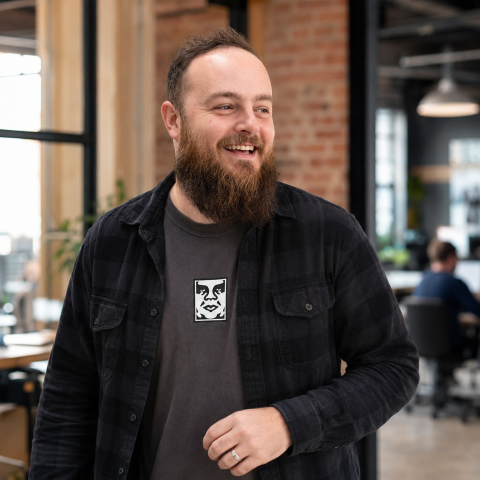Nathan, founder of Currents, in a bright brick-walled workspace.